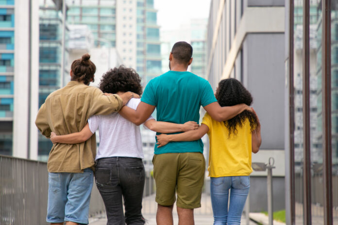 Back view of young people walking outdoors
